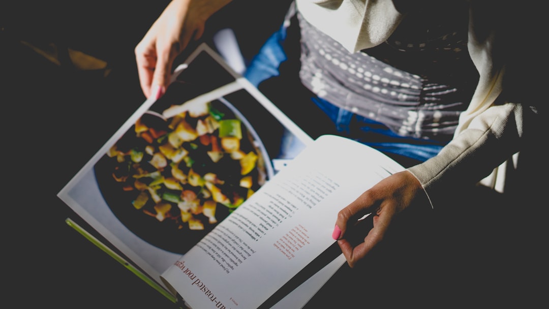 our-mission Person reads cookbook recipe